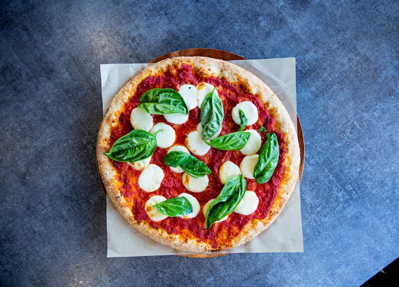 Margherita coal fired pizza on wooden board